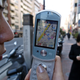 Nami Terai, KDDI Corp. spokesperson displays the mobile carrier's new service GPS, or global positioning system, in Tokyo Tuesday, March 9, 2004. The EZ Navi Walk system, which uses satellites to find out where the user is at any time works like car-navigation equipment to guide people to their destination.